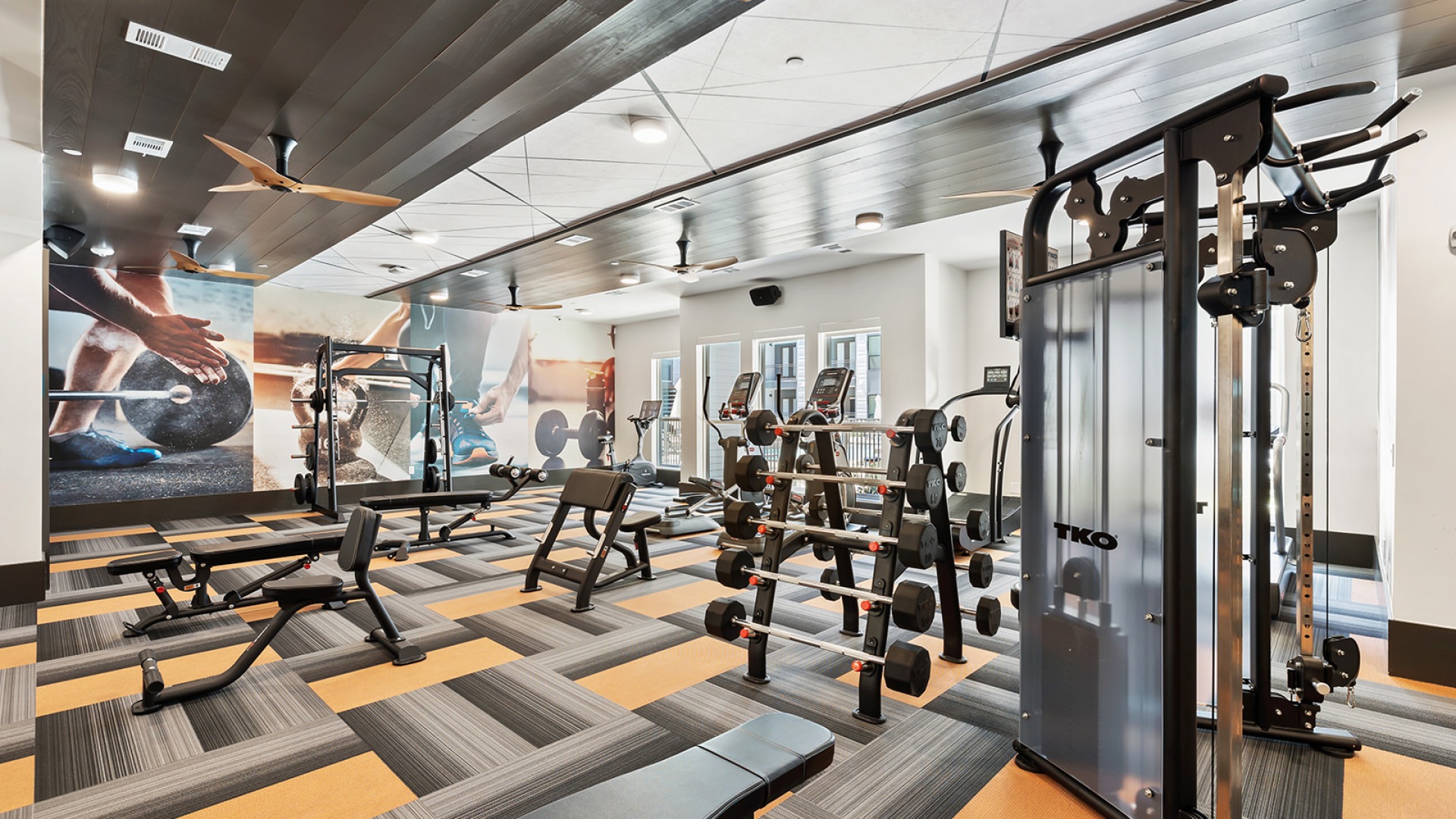 Cadmium fitness center at our apartments in Houston, featuring padded floors and exercise machines.